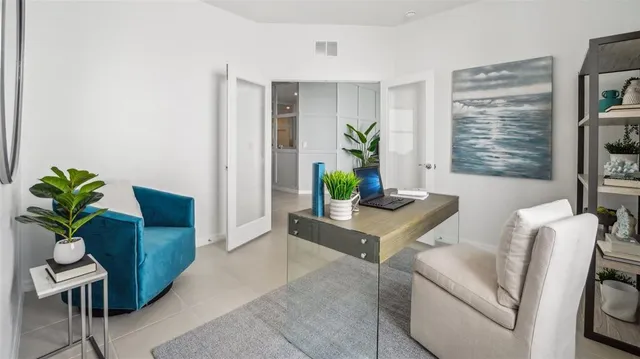 a living room with furniture and a potted plant