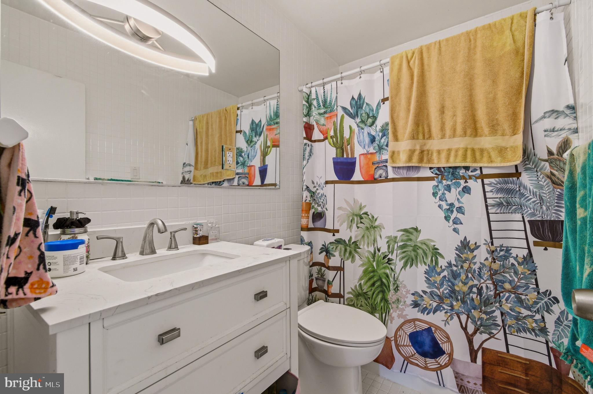 400 O Street Southwest, Unit 402 Washington, DC 20024 - Photo 19 of 34 a bathroom with a sink a toilet and a shower curtain