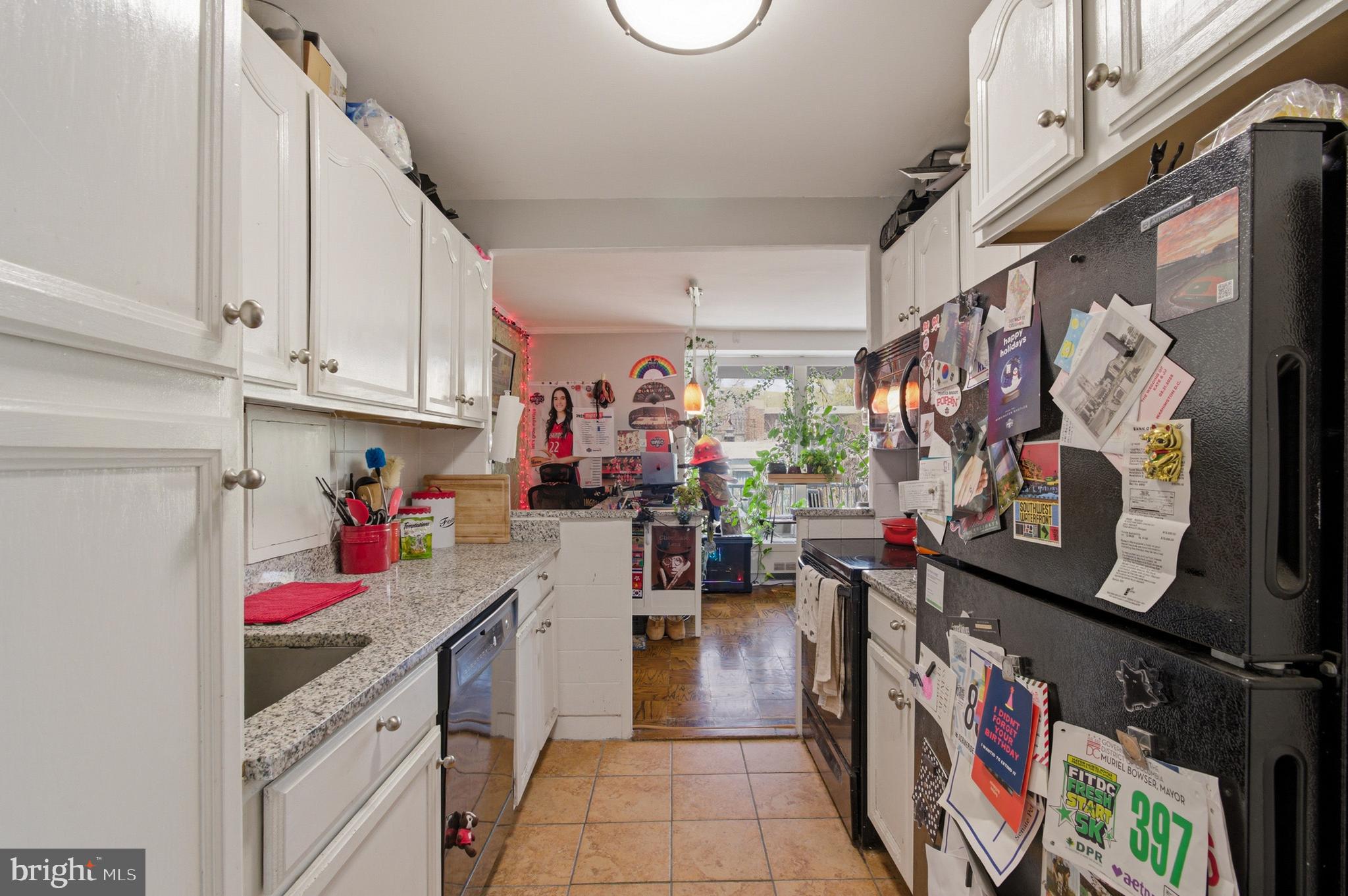 400 O Street Southwest, Unit 402 Washington, DC 20024 - Photo 21 of 34 a kitchen with lots of clutter and cabinets