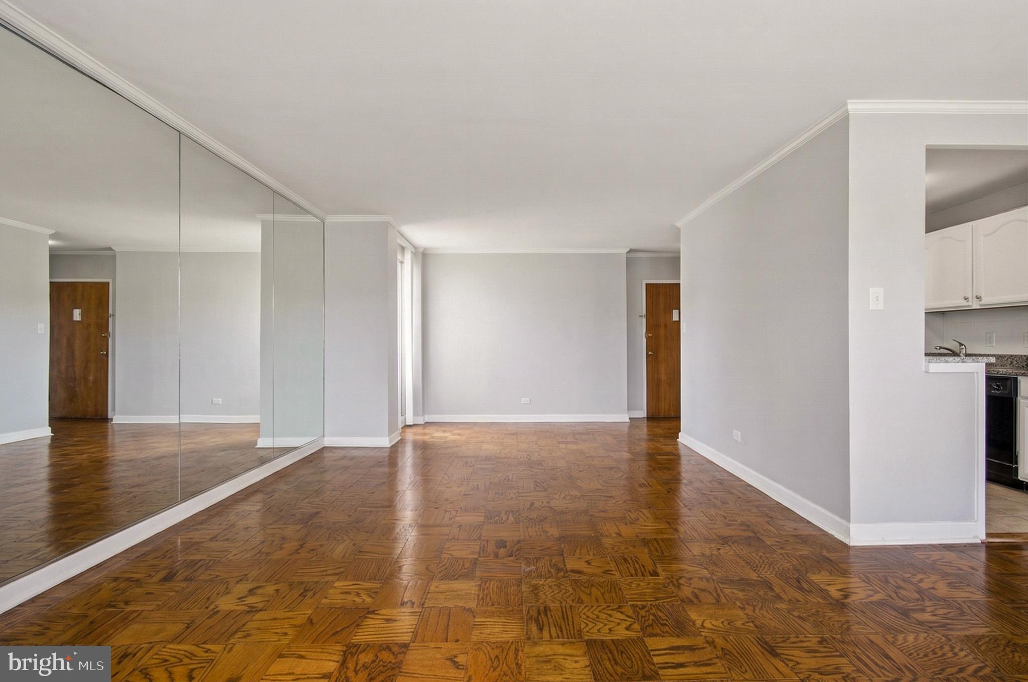 400 O Street Southwest, Unit 402 Washington, DC 20024 - Photo 3 of 34 a view of an empty room with kitchen and a window