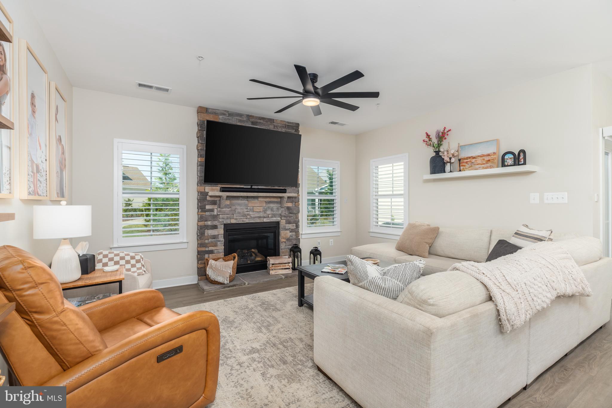 12125 Snug Harbor Road Berlin, MD 21811 - Photo 21 of 52 a living room with furniture a fireplace and a flat screen tv