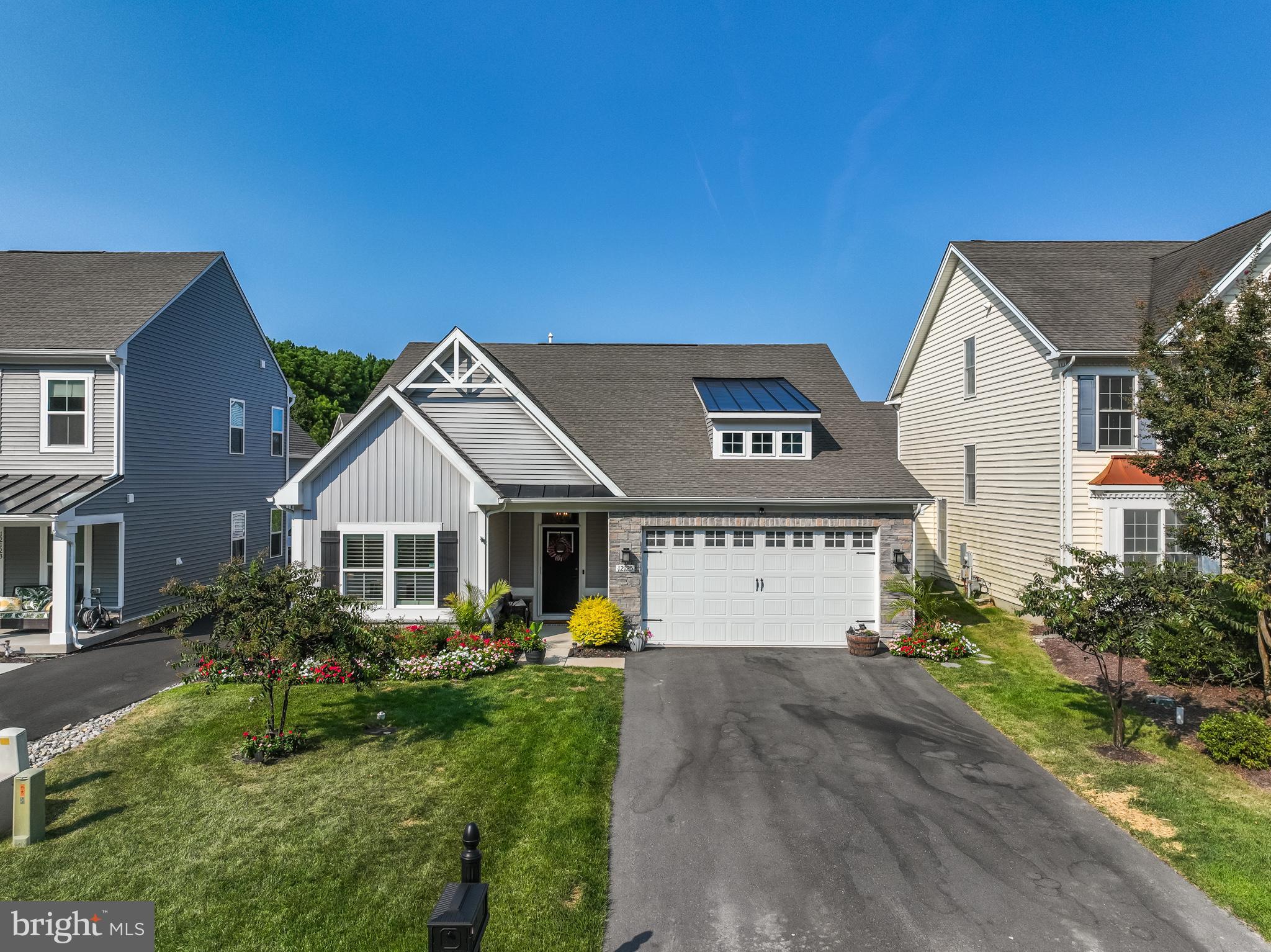 12125 Snug Harbor Road Berlin, MD 21811 - Photo 3 of 52 a front view of a house with a yard and garage