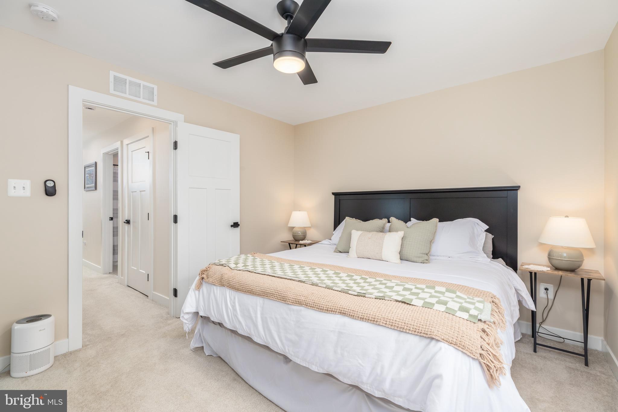 12125 Snug Harbor Road Berlin, MD 21811 - Photo 42 of 52 a bedroom with a bed and a lamp