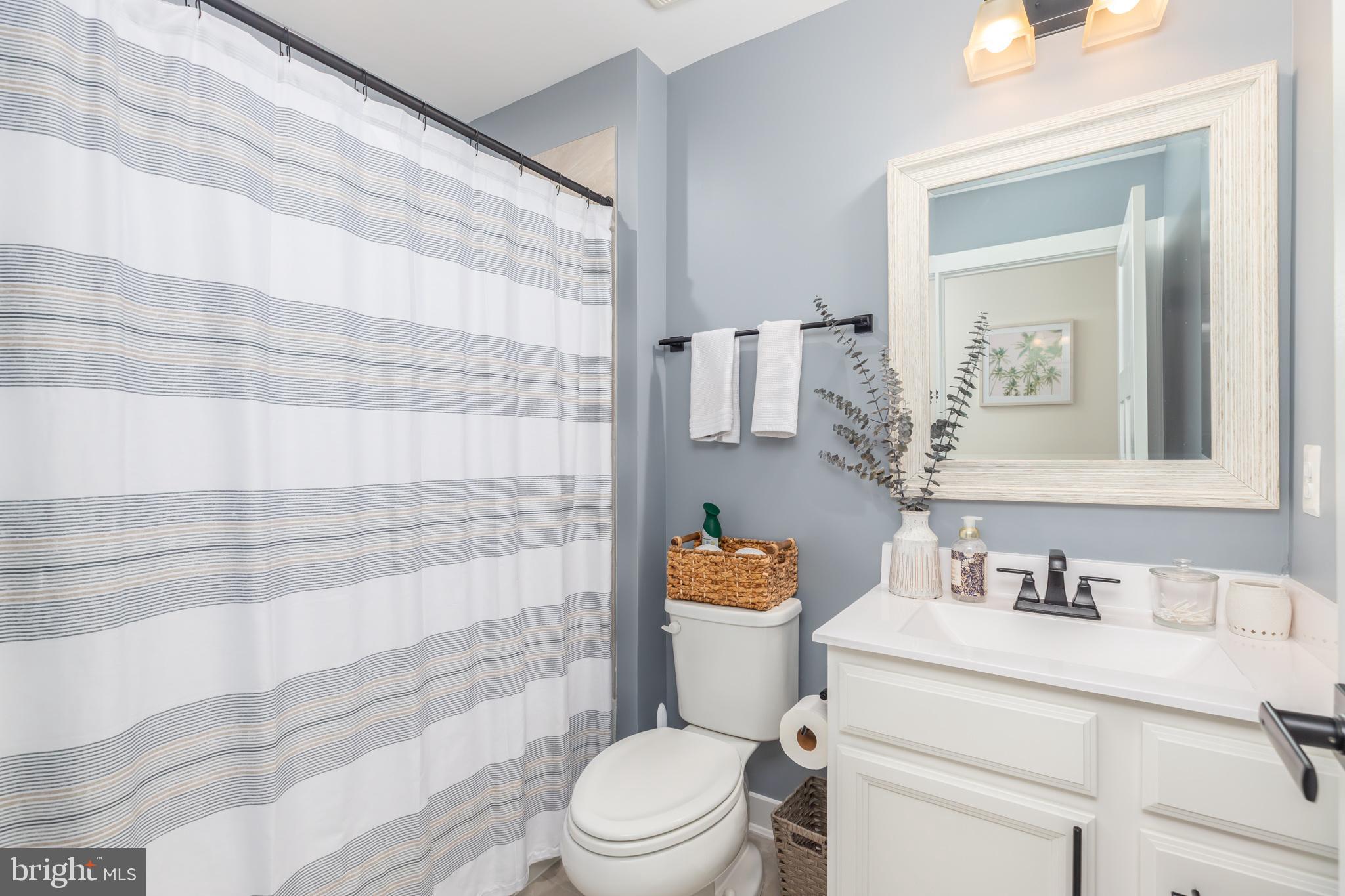 12125 Snug Harbor Road Berlin, MD 21811 - Photo 43 of 52 a bathroom with a sink toilet vanity and shower