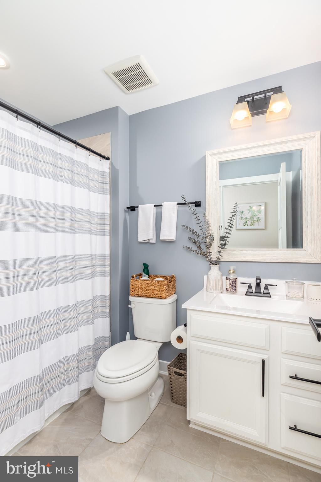 12125 Snug Harbor Road Berlin, MD 21811 - Photo 44 of 52 a bathroom with a toilet sink and mirror