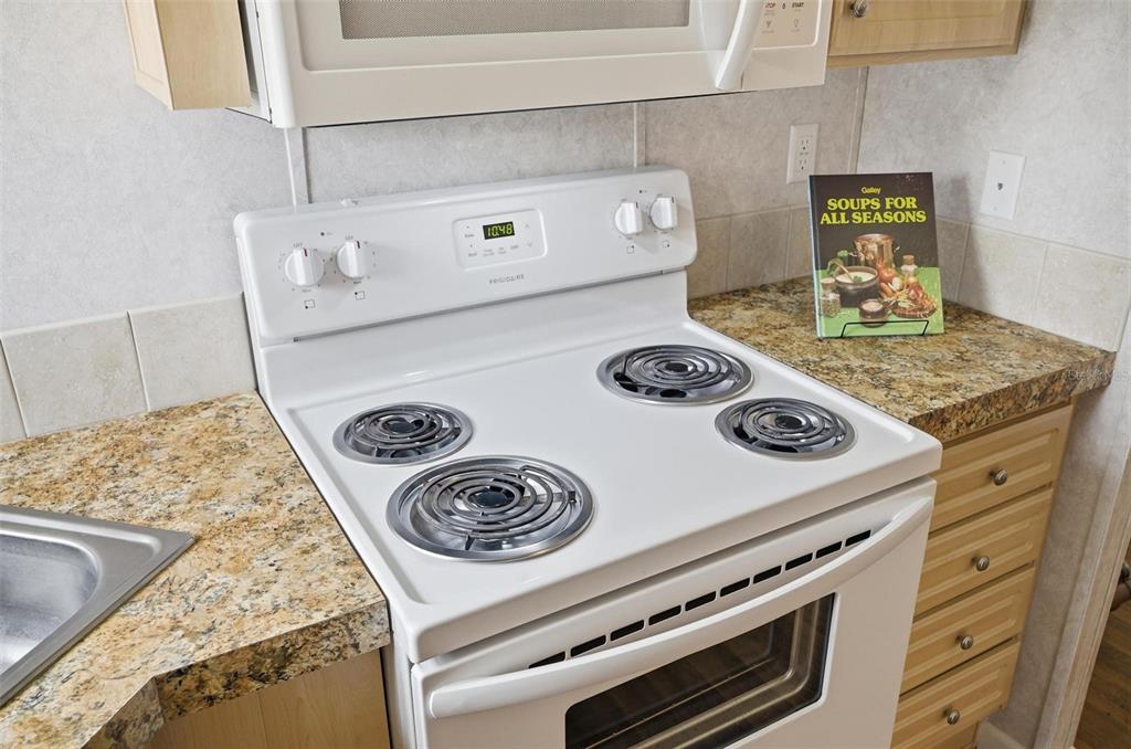 55716 Keith Street Astor, FL 32102 - Photo 15 of 32 a stove top oven sitting inside of a kitchen
