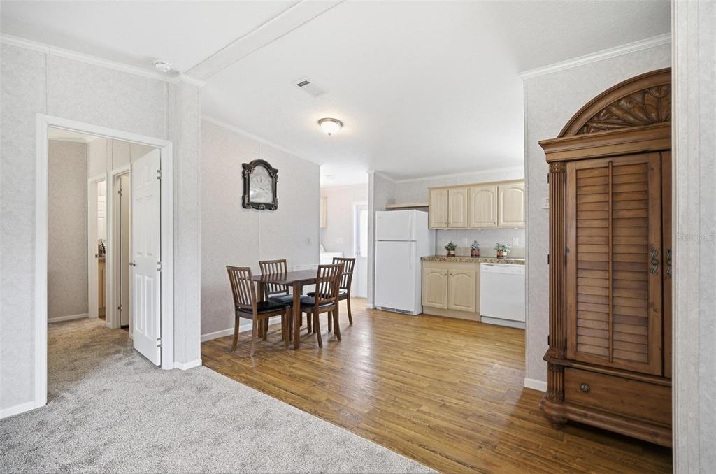 55716 Keith Street Astor, FL 32102 - Photo 19 of 32 a view of a dining room kitchen with furniture and wooden floor