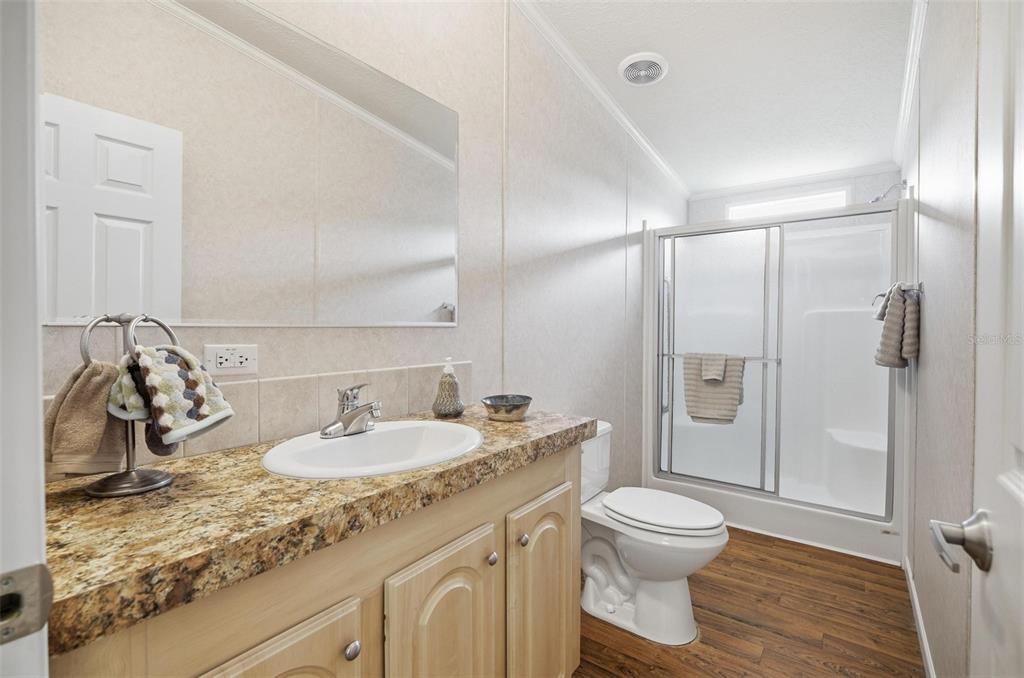 55716 Keith Street Astor, FL 32102 - Photo 23 of 32 a bathroom with a granite countertop sink toilet and shower