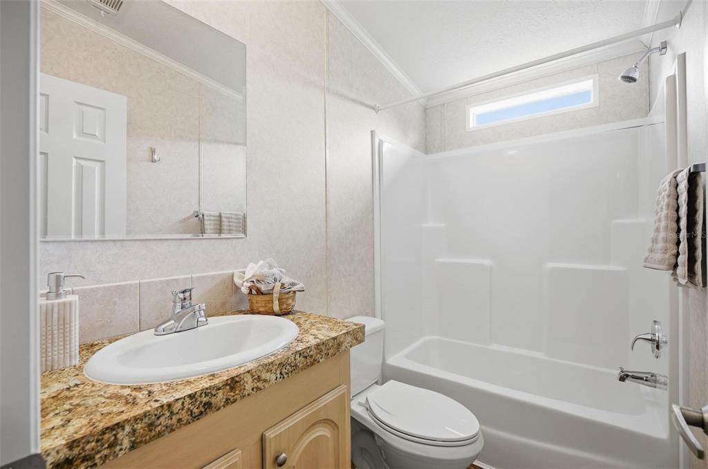 55716 Keith Street Astor, FL 32102 - Photo 26 of 32 a bathroom with a granite countertop sink toilet and shower