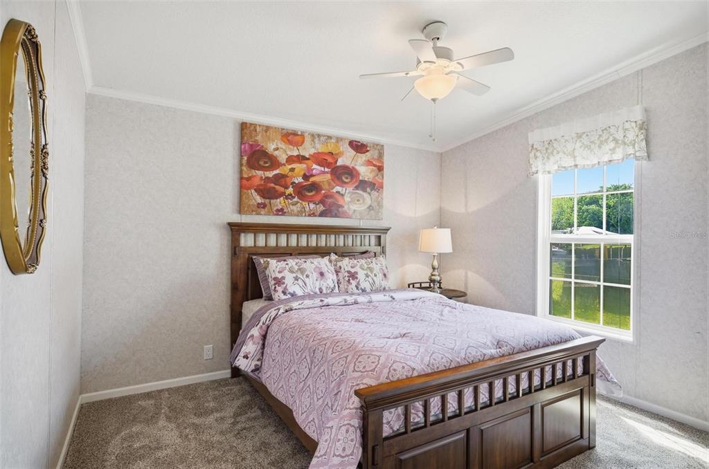55716 Keith Street Astor, FL 32102 - Photo 28 of 32 a bedroom with a bed and a chandelier