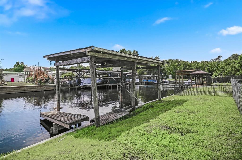 55716 Keith Street Astor, FL 32102 - Photo 4 of 32 a view of a lake with a house in the background