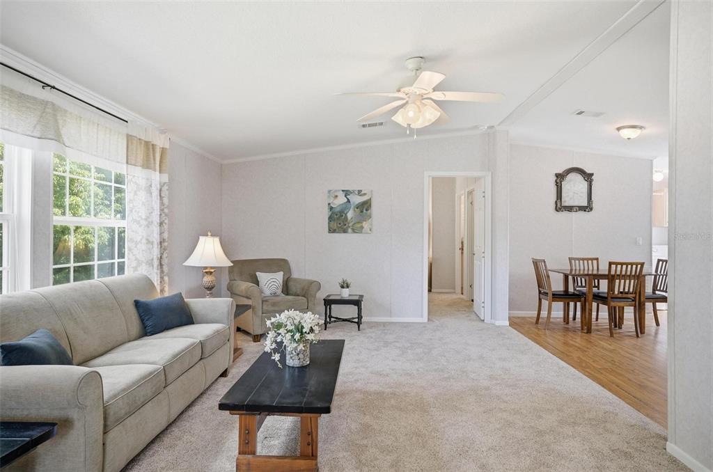 55716 Keith Street Astor, FL 32102 - Photo 10 of 32 a living room with furniture wooden floor and a large window