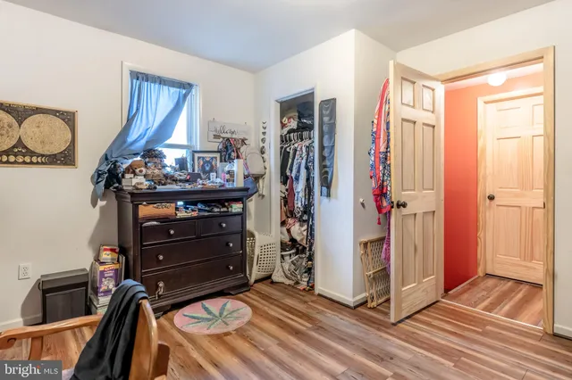 a bedroom with furniture and a flat screen tv