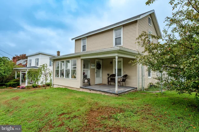 a front view of a house with garden and porch