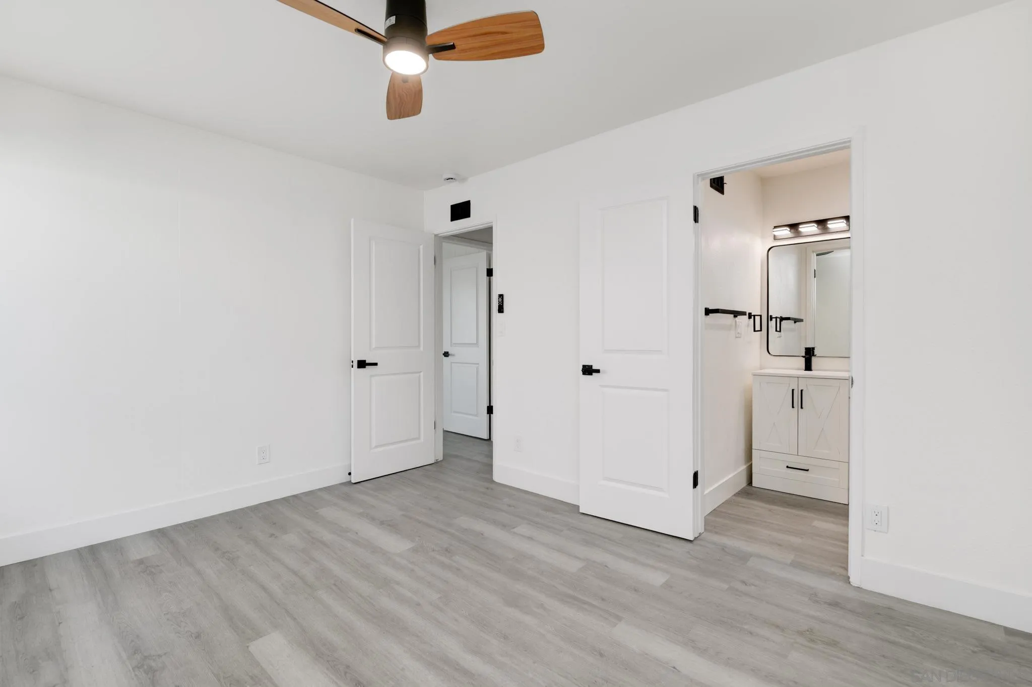 8667 Cetus Road San Diego, CA 92126 - Photo 12 of 22 an empty room with wooden floor