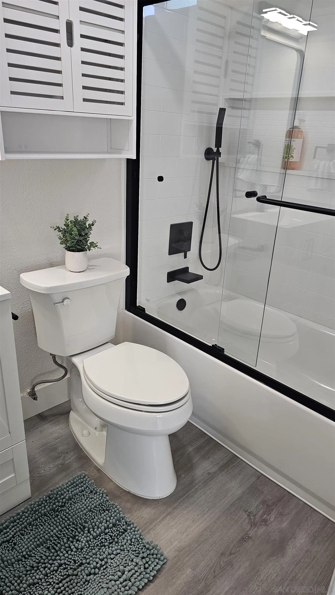 8667 Cetus Road San Diego, CA 92126 - Photo 13 of 22 a white toilet sitting next to a bathroom sink