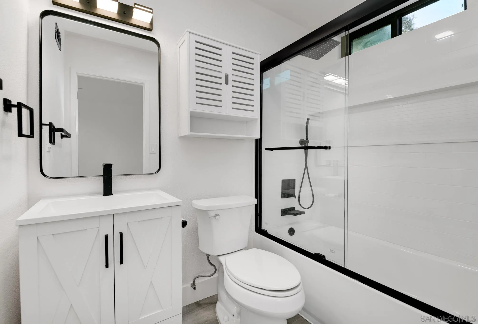 8667 Cetus Road San Diego, CA 92126 - Photo 14 of 22 a bathroom with a toilet sink and shower