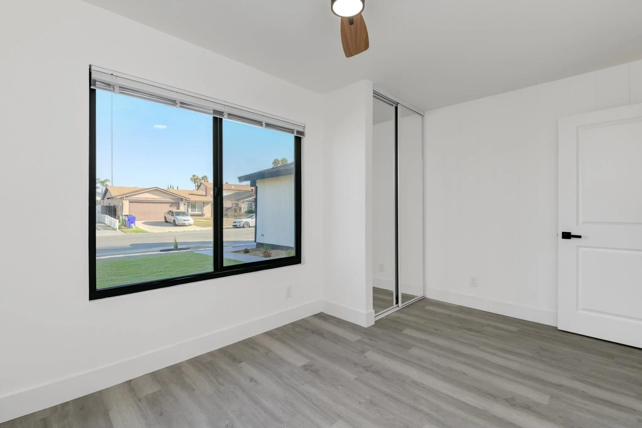 8667 Cetus Road San Diego, CA 92126 - Photo 15 of 22 a view of a room with wooden floor and window
