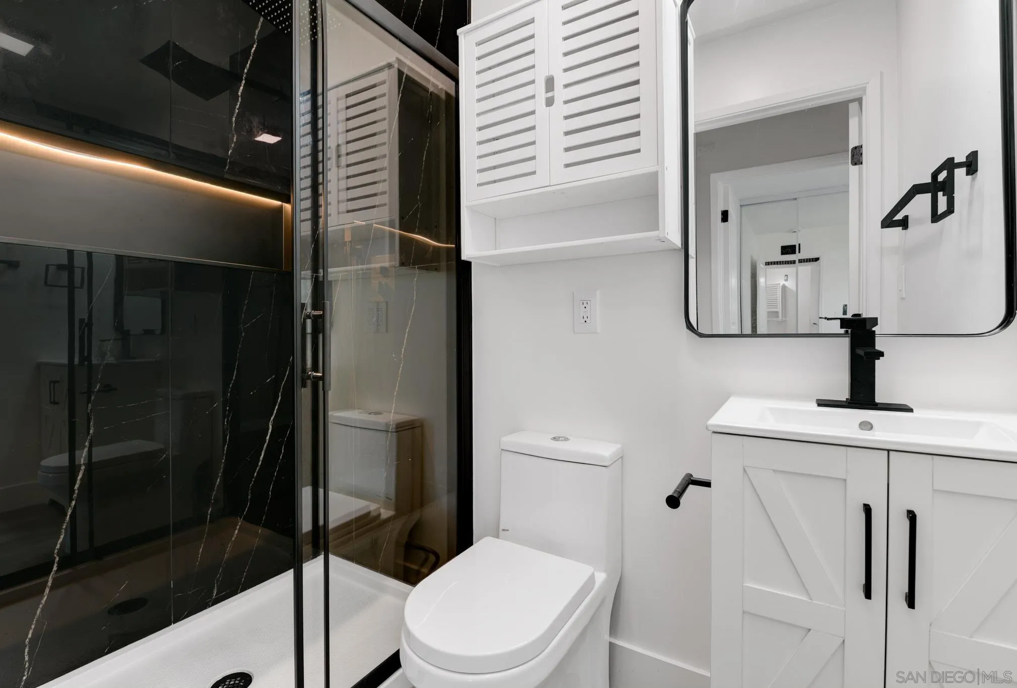 8667 Cetus Road San Diego, CA 92126 - Photo 17 of 22 a bathroom with a toilet a sink and shower