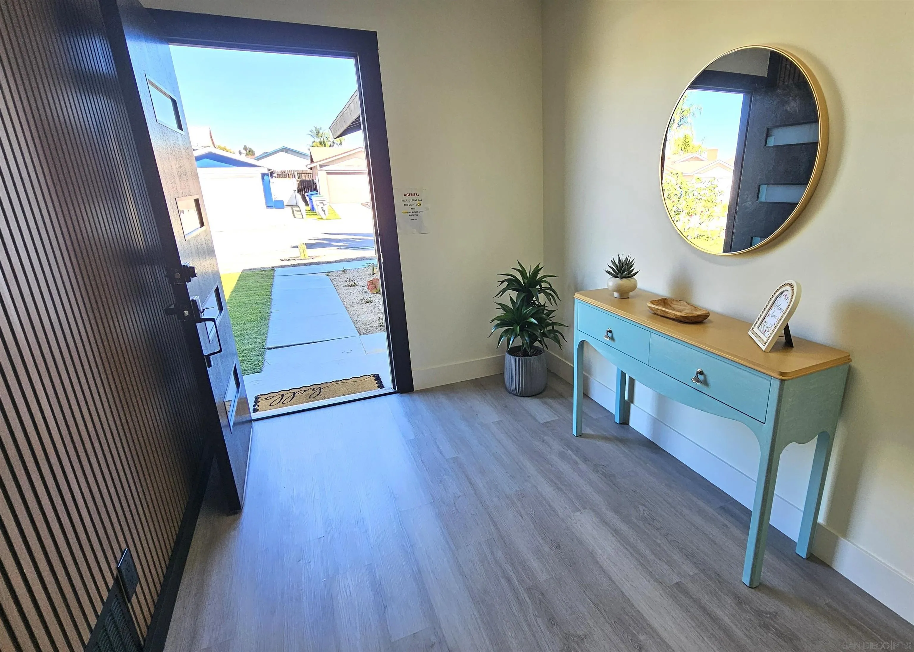 8667 Cetus Road San Diego, CA 92126 - Photo 4 of 22 a room with wooden floor and a mirror