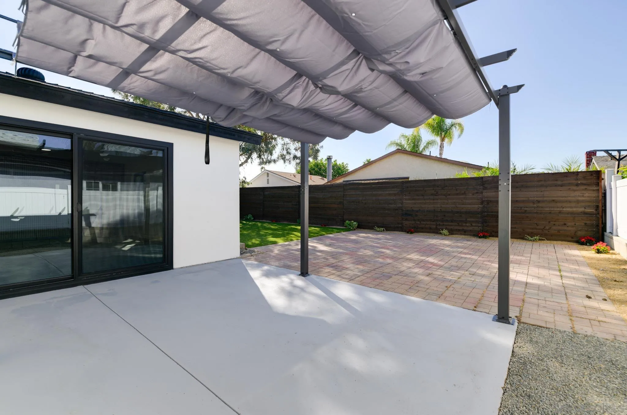 8667 Cetus Road San Diego, CA 92126 - Photo 9 of 22 a patio with a table and chairs