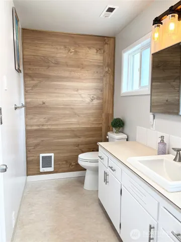 a spacious bedroom with a bed and a cabinets