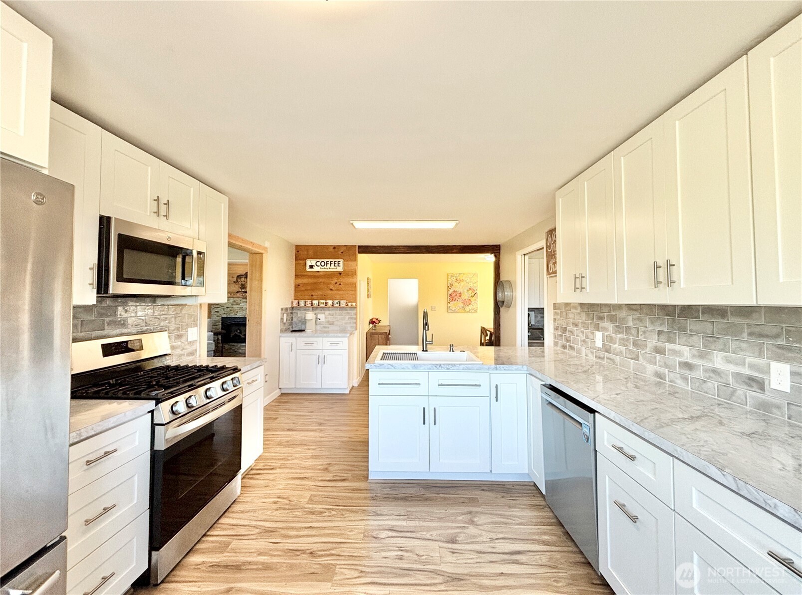 2452 Aldergrove Road Ferndale, WA 98248 - Photo 18 of 37 a large kitchen with stainless steel appliances granite countertop a stove a sink and a white cabinets