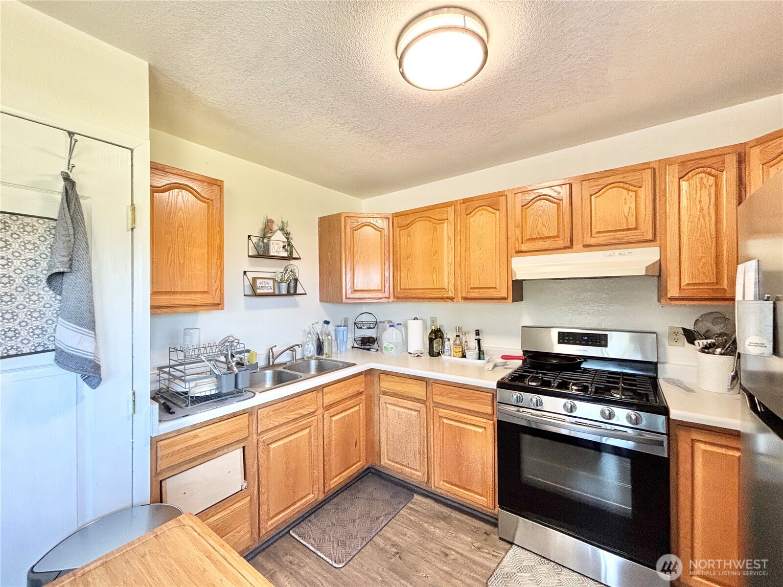 2452 Aldergrove Road Ferndale, WA 98248 - Photo 34 of 37 a kitchen with stainless steel appliances a stove a sink and a refrigerator