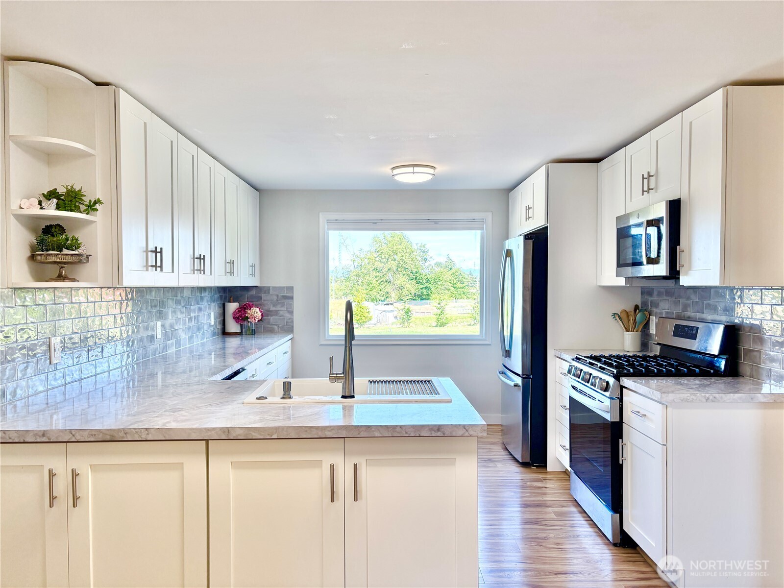 2452 Aldergrove Road Ferndale, WA 98248 - Photo 4 of 37 a kitchen with granite countertop a sink a counter space appliances and cabinets