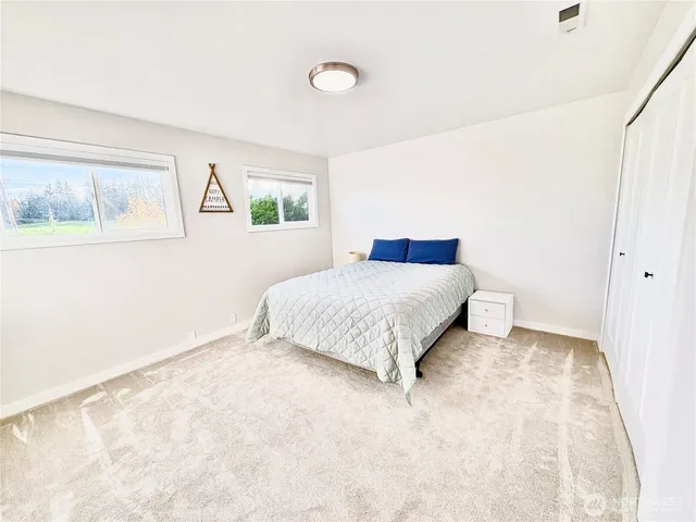 a bathroom with a sink vanity toilet and a mirror