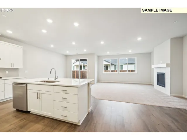 a large white kitchen with a large window