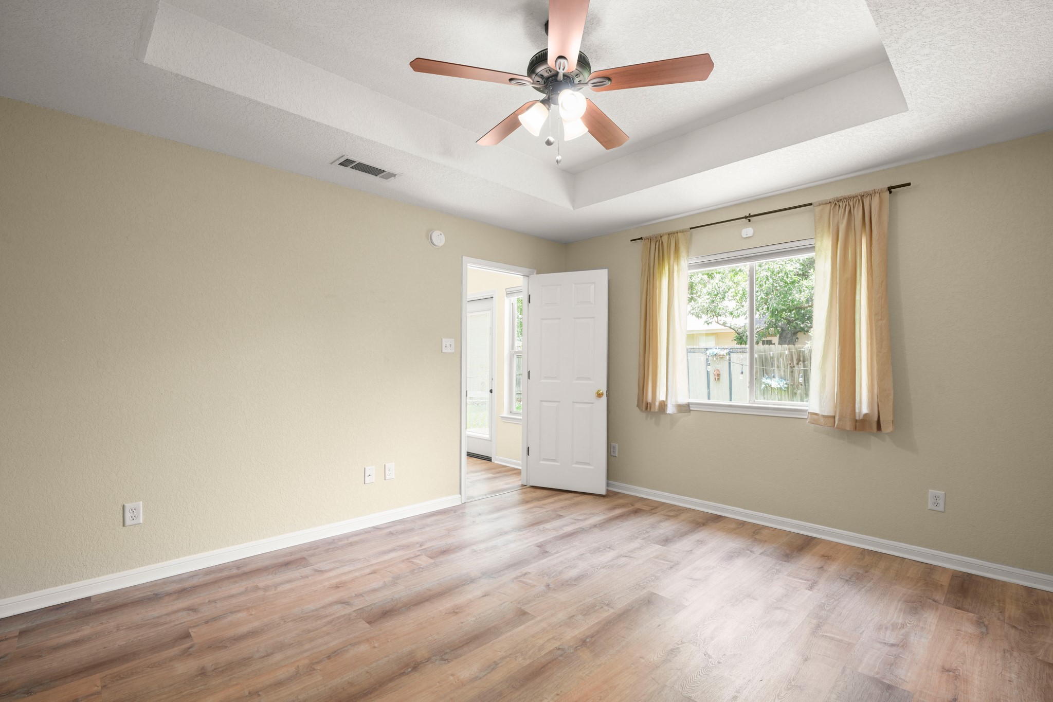 438 Katy Crossing Georgetown, TX 78626 - Photo 11 of 24 A tray ceiling and rich wood flooring enhance this airy, naturally illuminated room.