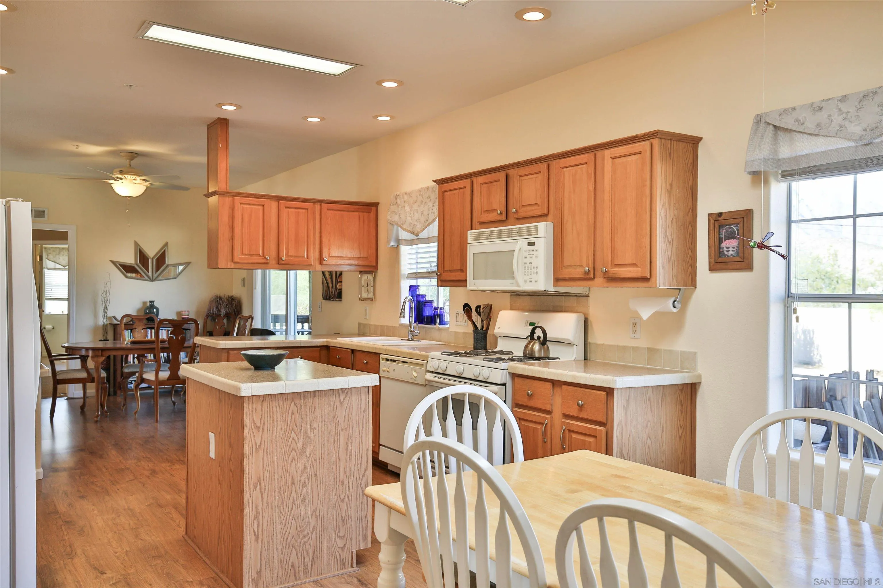 2846 Frying Pan Road Borrego Springs, CA 92004 - Photo 13 of 27 a kitchen with kitchen island a stove a sink a dining table and chairs