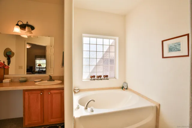 a bathroom with a double vanity sink and a mirror