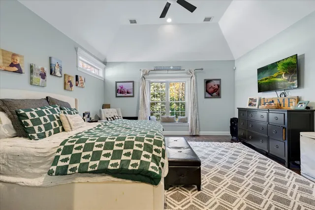 a bedroom with double bed and a flat tv screen on dresser