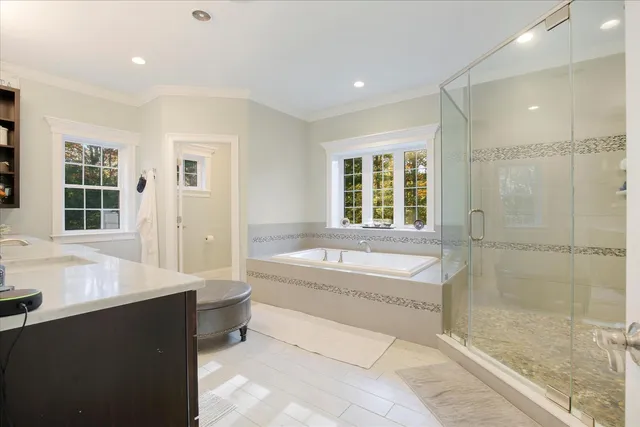 a spacious bathroom with a bathtub and a sink