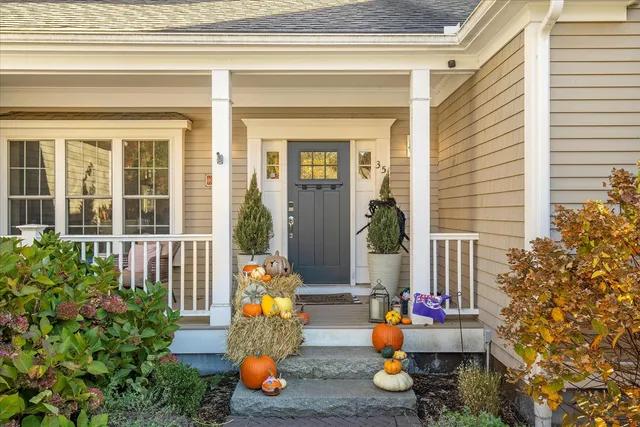 a front view of a house with outdoor seating