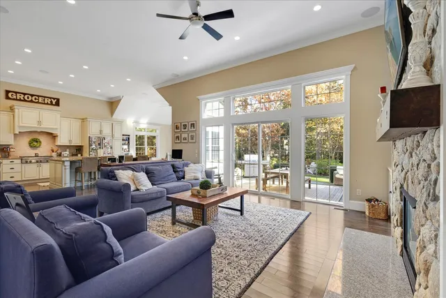 a living room with furniture a flat screen tv and a floor to ceiling window