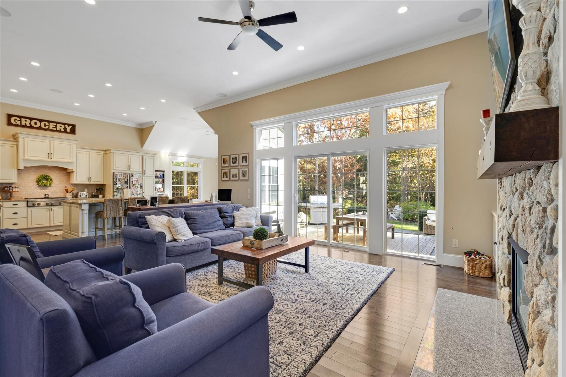 35 Spinnaker Drive West Mashpee, MA 02649 - Photo 9 of 59 a living room with furniture a flat screen tv and a floor to ceiling window