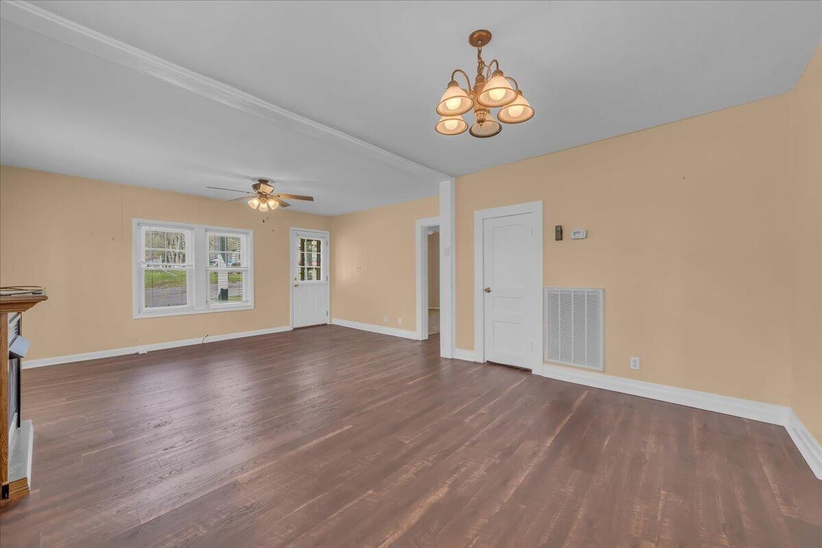 120 Raulstontown Road South Pittsburg, TN 37380 - Photo 8 of 22 a view of an empty room with a window and wooden floor