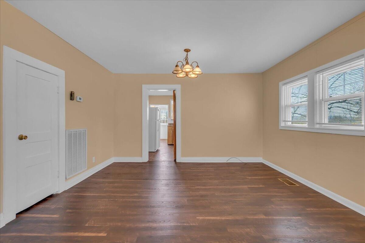 120 Raulstontown Road South Pittsburg, TN 37380 - Photo 9 of 22 a view of an empty room with wooden floor and a window