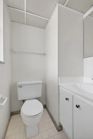 a white toilet sitting next to a bathroom sink
