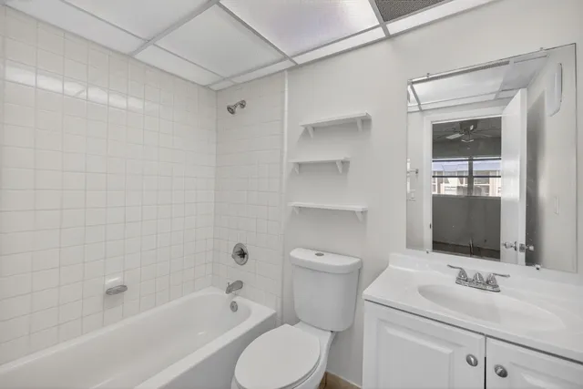a bathroom with a sink toilet vanity and shower