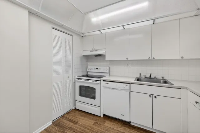 a kitchen with cabinets appliances and a sink