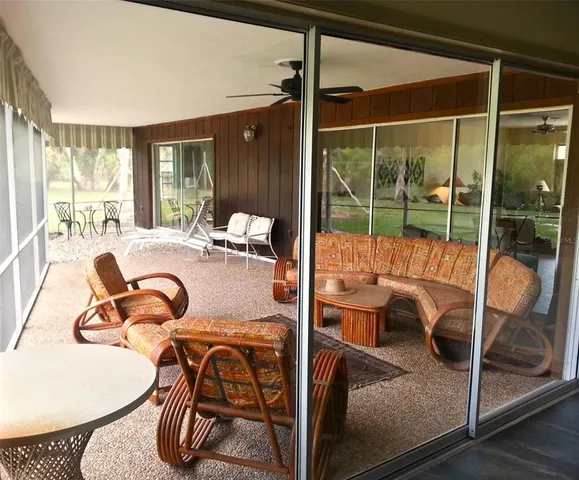 a view of a patio with table and chairs