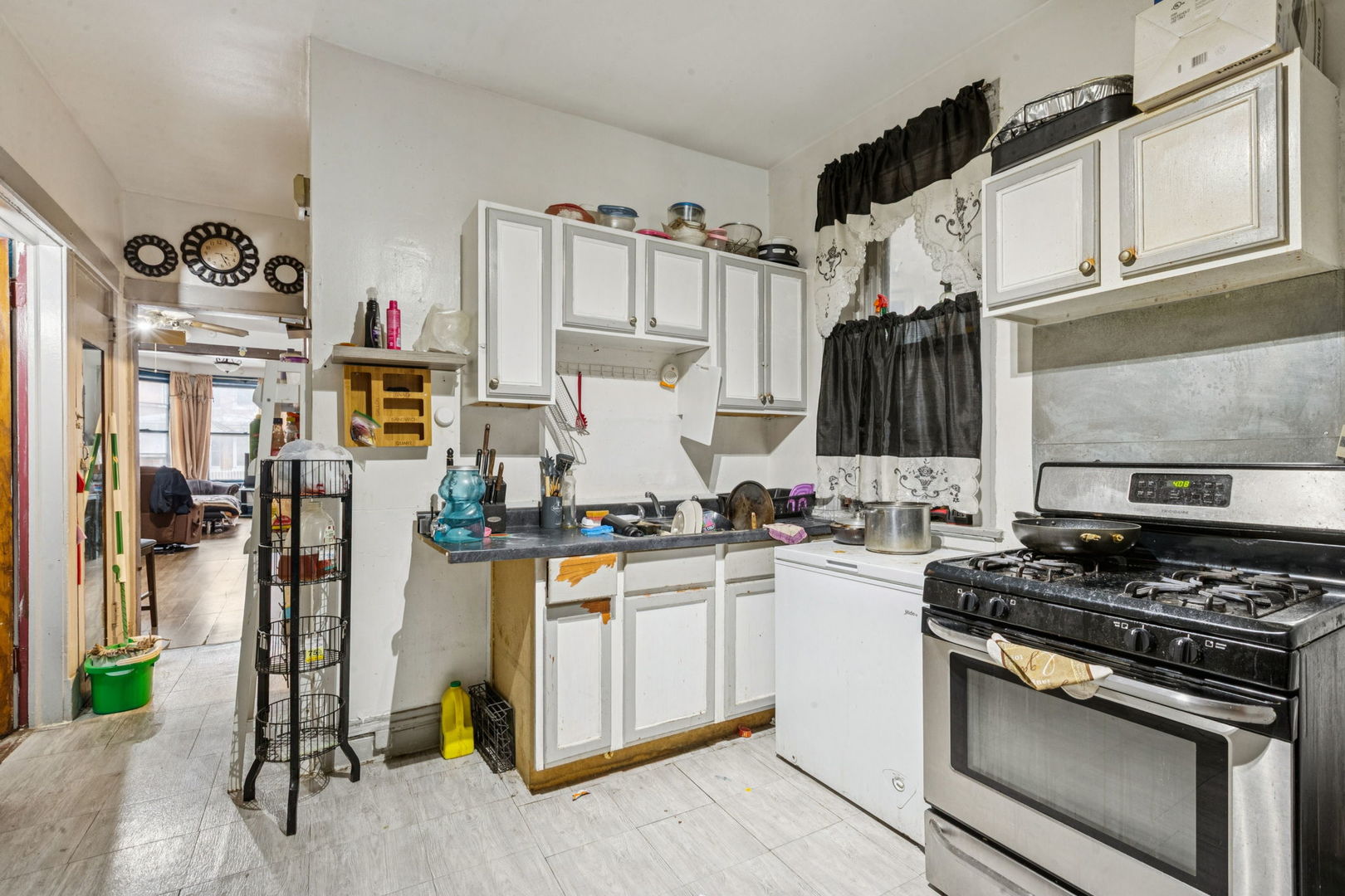 1012 North Ridgeway Avenue Chicago, IL 60651 - Photo 15 of 31 a kitchen with stainless steel appliances granite countertop a stove and a refrigerator