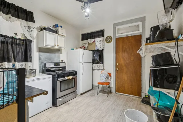 a kitchen with stainless steel appliances granite countertop a refrigerator sink and stove