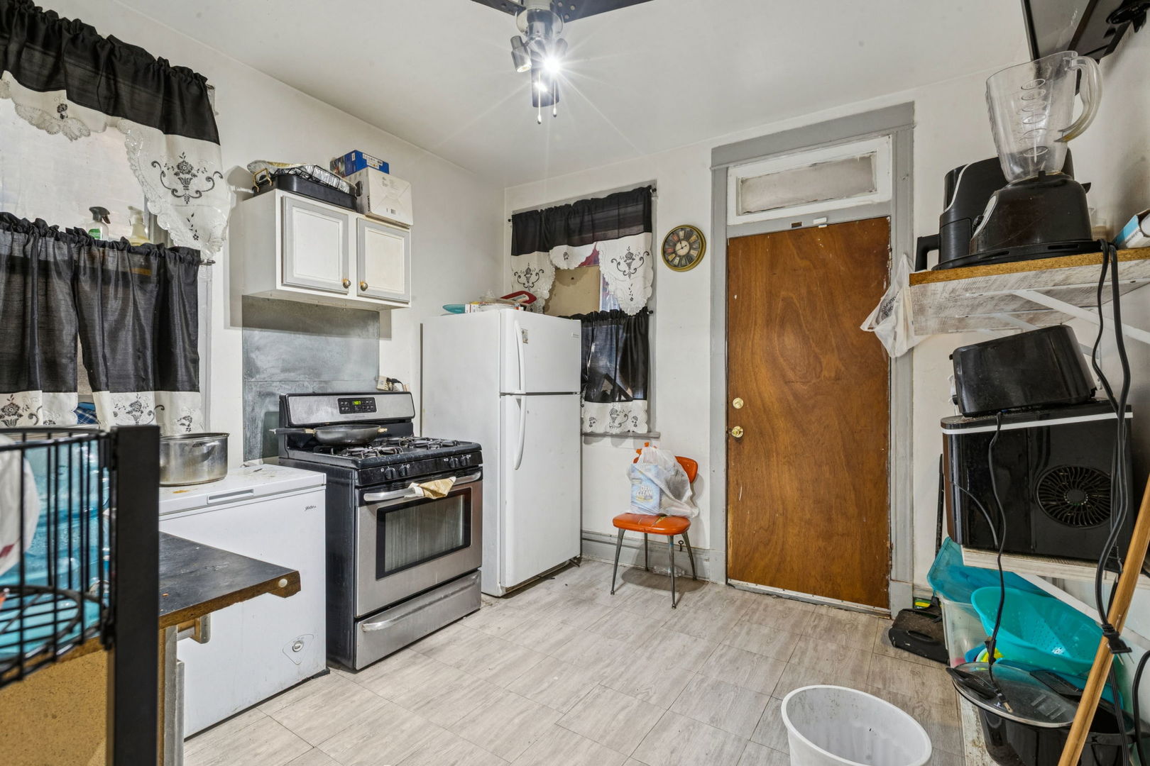 1012 North Ridgeway Avenue Chicago, IL 60651 - Photo 16 of 31 a kitchen with stainless steel appliances granite countertop a refrigerator sink and stove