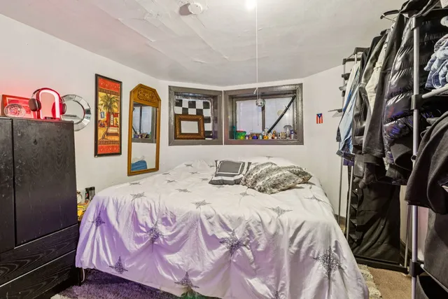 a bedroom with a bed and a dresser