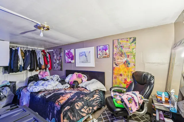 a bedroom with two beds and a bed